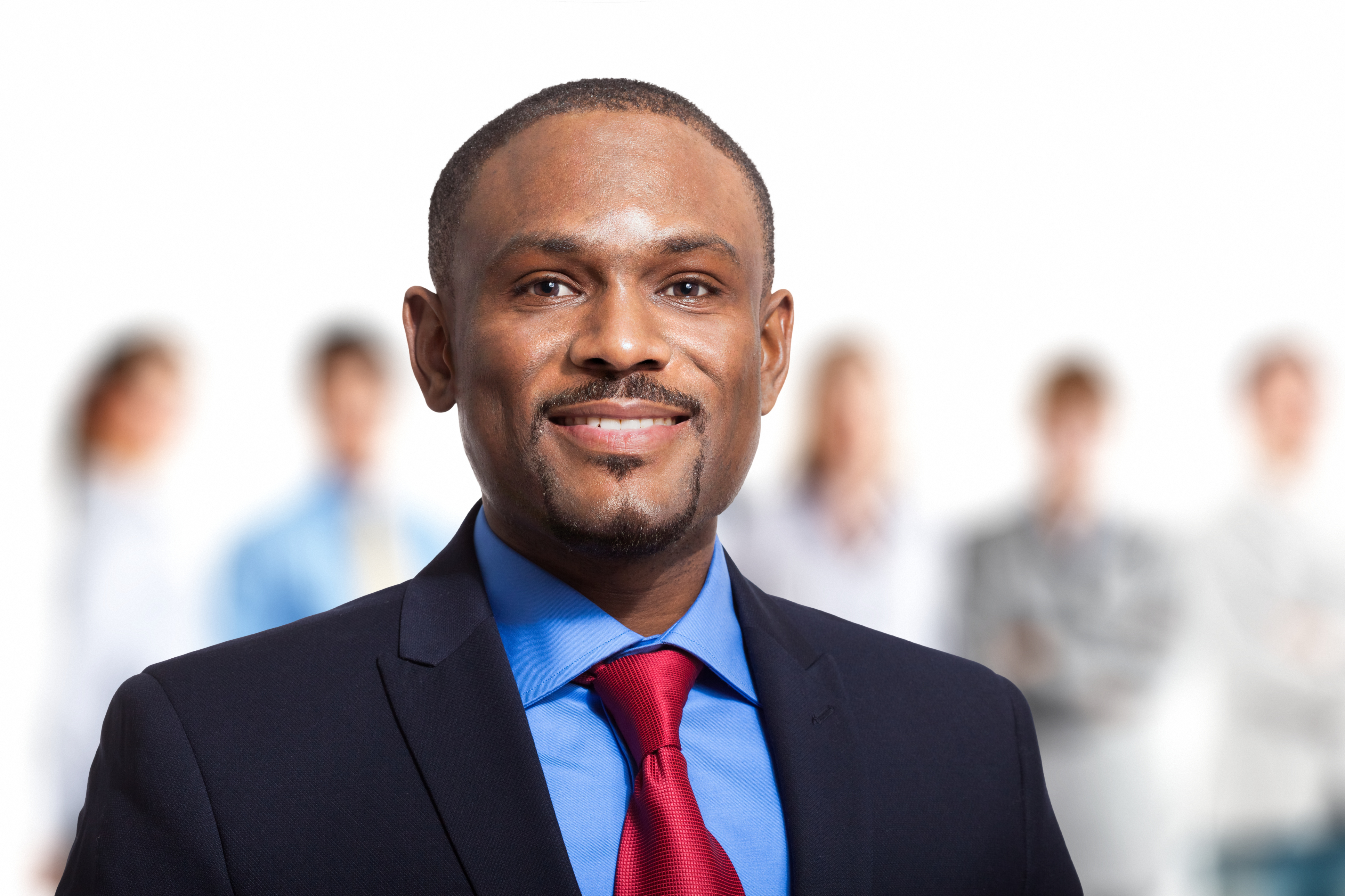 Smiling businessman in front of a group of people