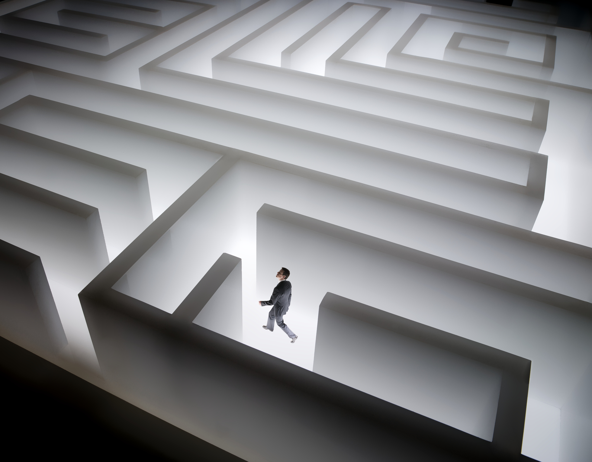 Man walking in giant maze business challenges