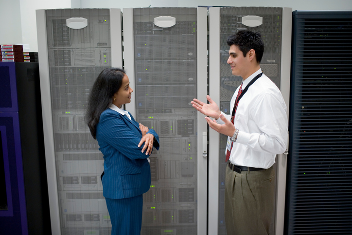 Businesspeople talking in server room IT department