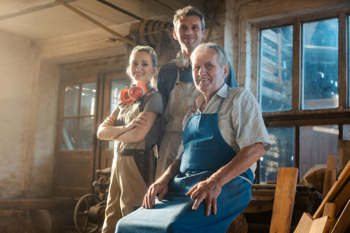 Generations,Of,Carpenters,In,Their,Family,Business,Workshop,Looking,At family business